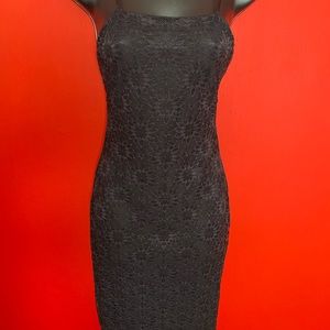 This black spaghetti strapped dress is form fitting and has a split in the back.